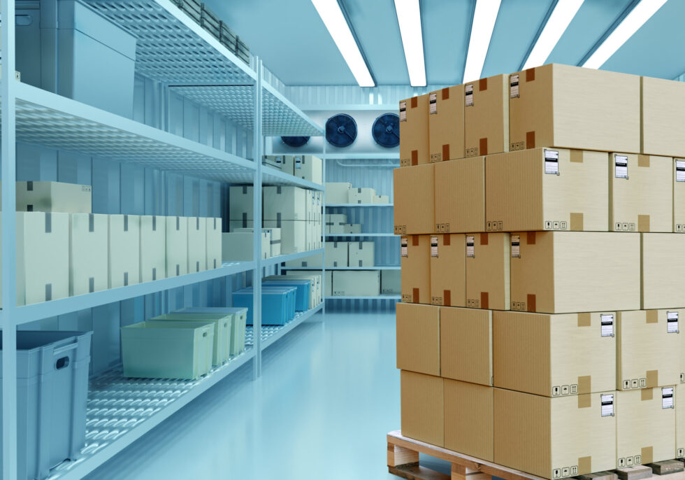 Wire shelving racks stocked with cases inside a cold storage room